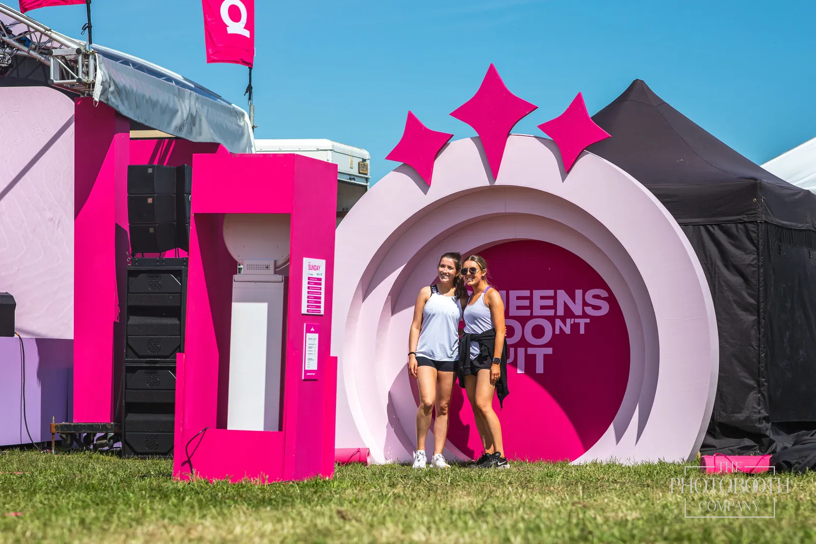 Guests posing at a large branded photo installation during an outdoor brand activation
