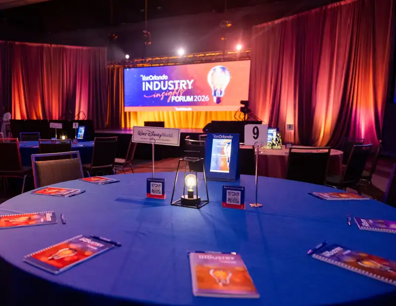 A round table and event signage before the program.