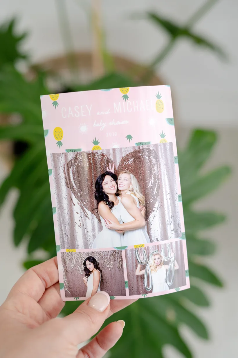 Custom wedding photo booth print design held by a guest