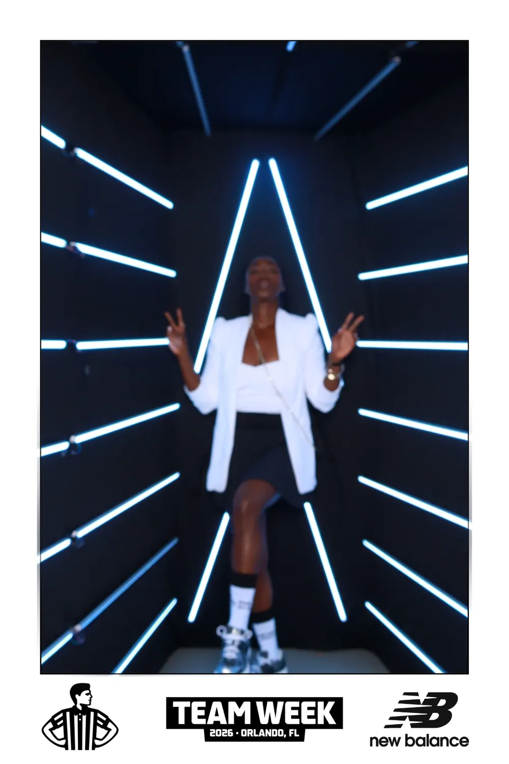 Guest posing for a full-length portrait in the branded Vogue booth
