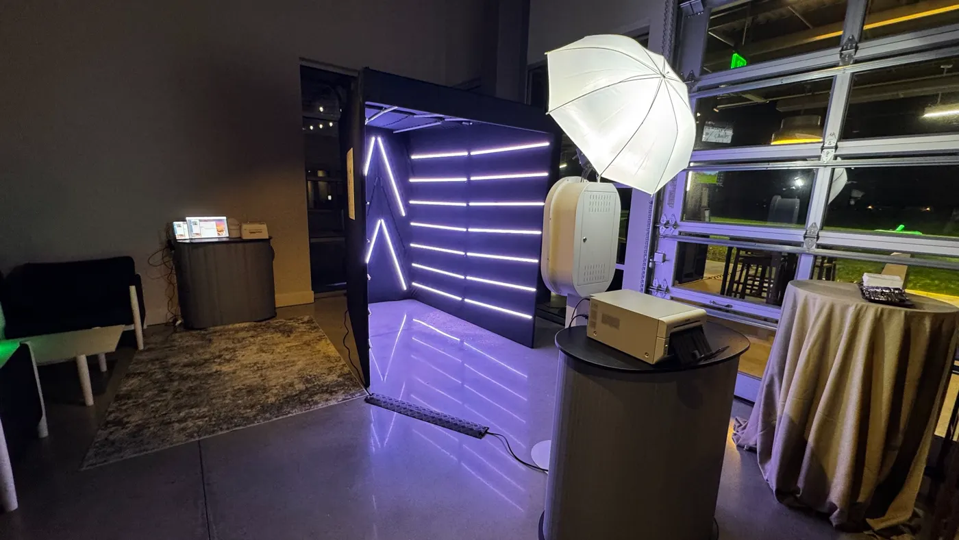 Vogue booth, camera, lighting and printing equipment arranged in a tight venue corner