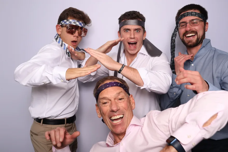 Wedding guests being playful together in an Orlando photo booth