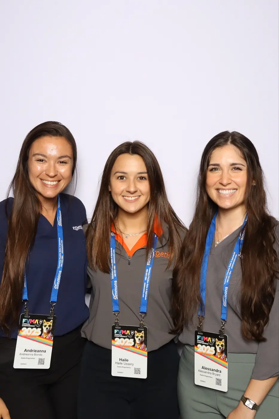 Three smiling FVMA Annual Conference guests at the photo experience