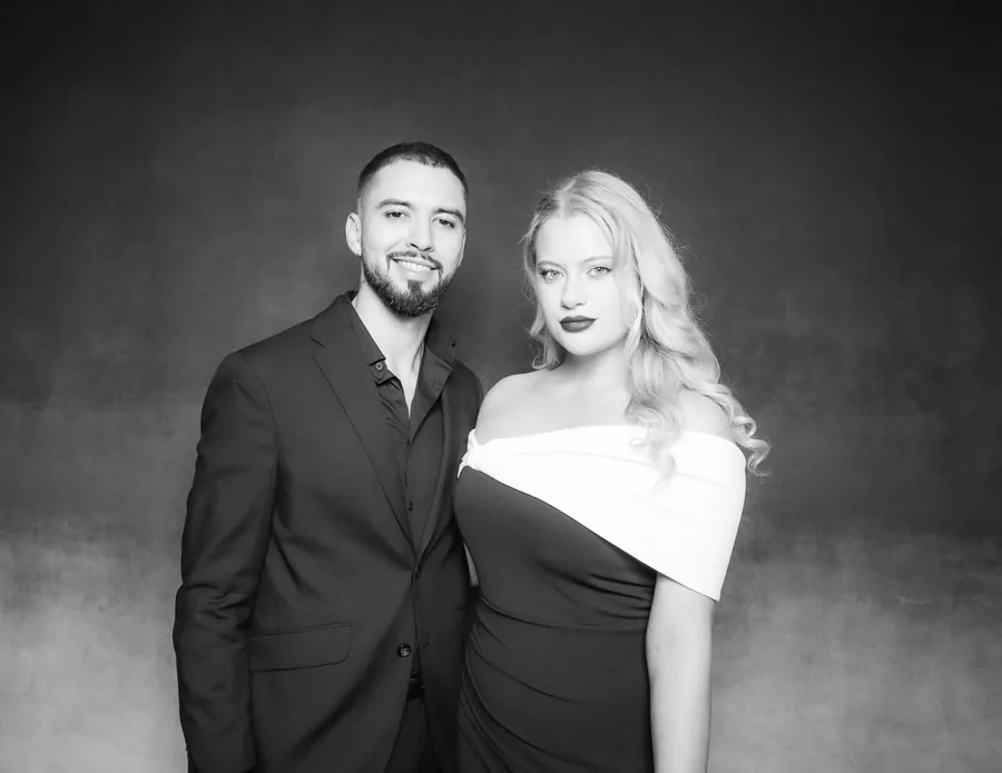 Glam wedding photo booth portrait of a couple on a dark editorial backdrop in Orlando