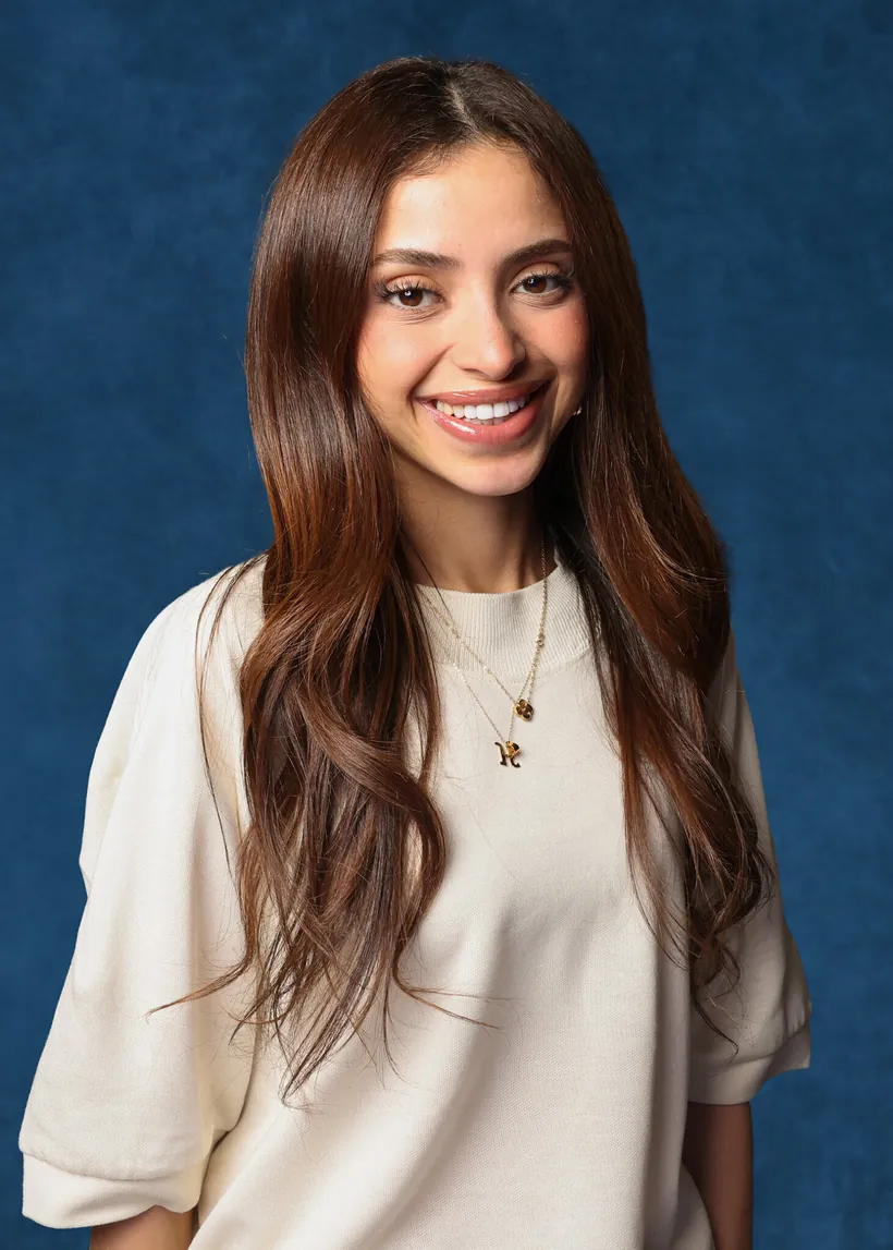 Professional headshot on a blue studio backdrop