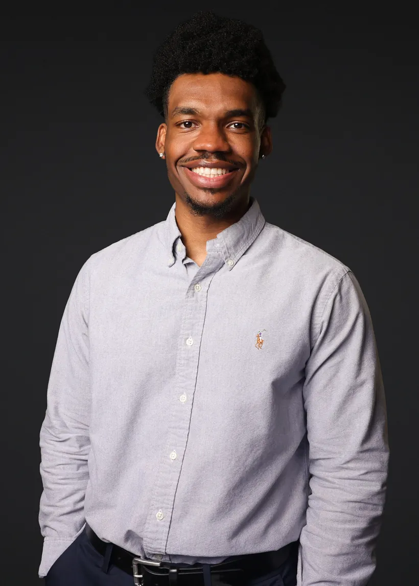Headshot booth portrait on a clean gray backdrop