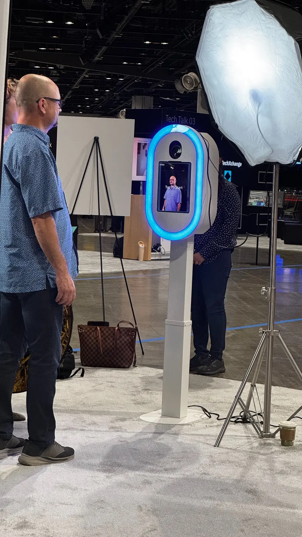 IBM TechXchange attendee using a staffed headshot station with studio lighting