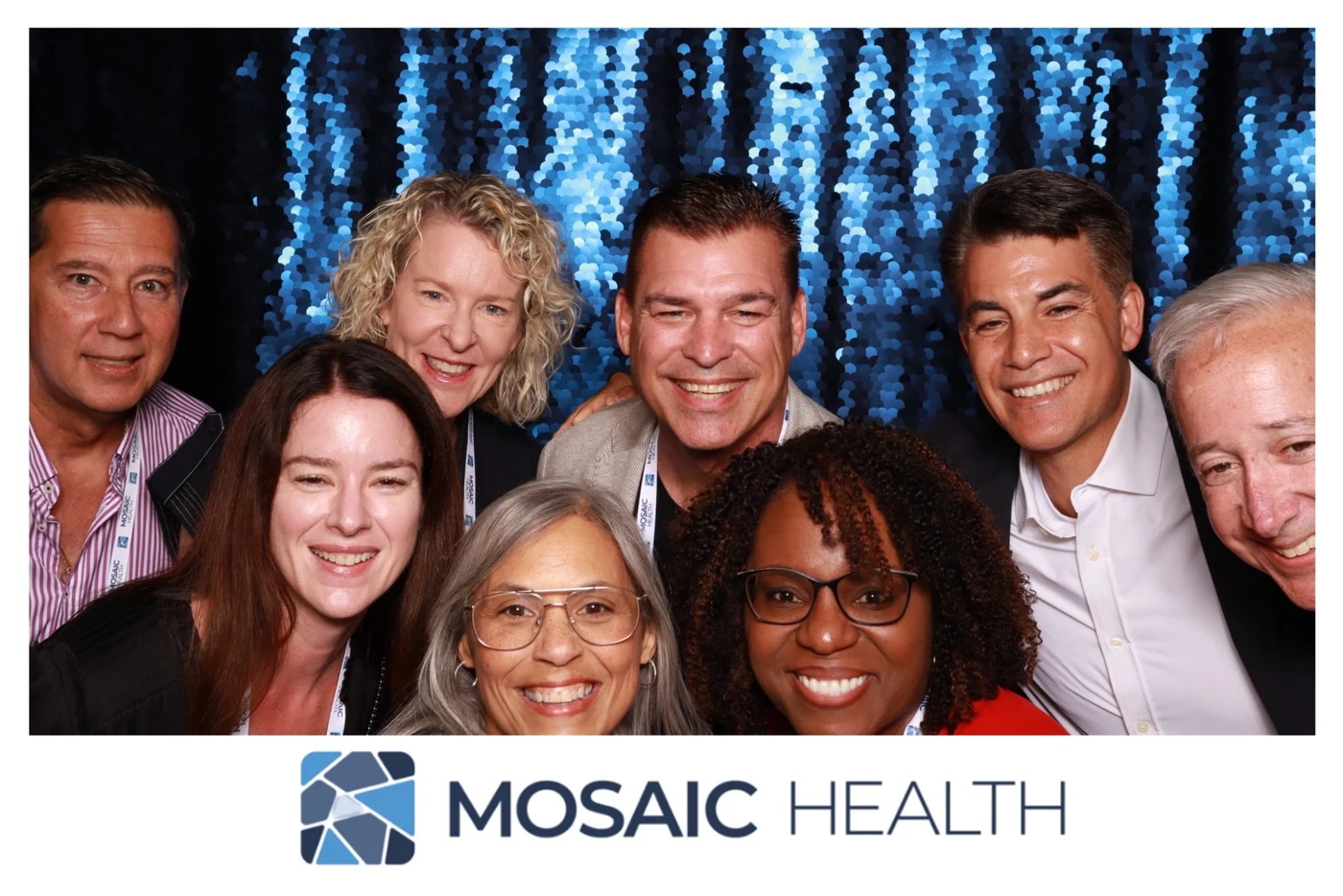 Mosaic Health colleagues smiling together at the retreat photo booth