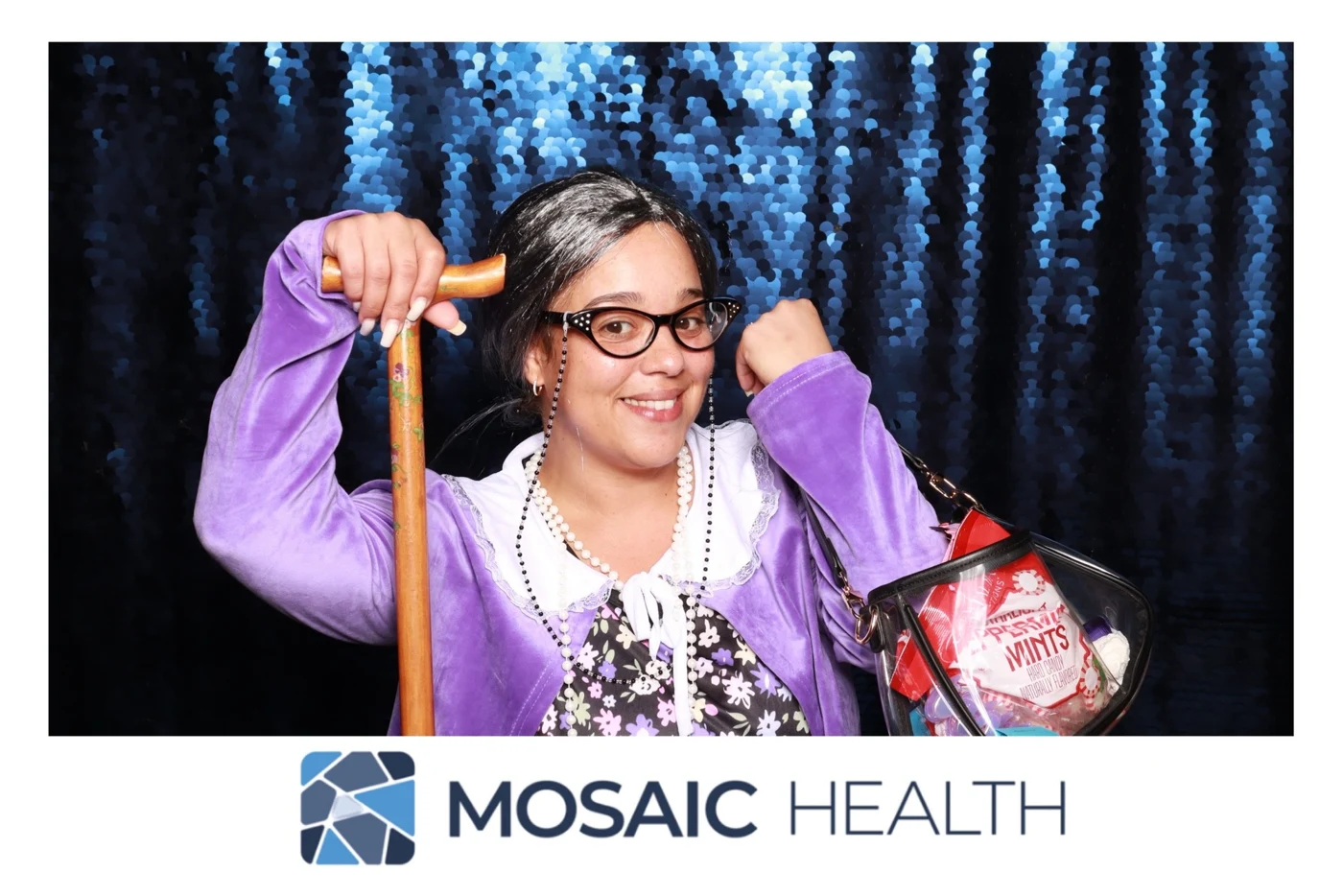 Mosaic Health retreat guest striking a playful pose at the photo booth