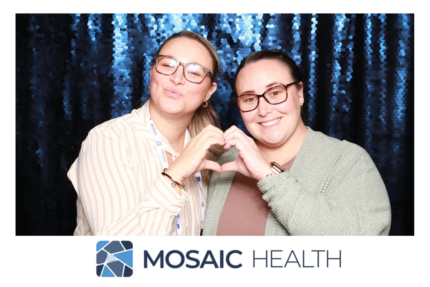 Two Mosaic Health guests making a heart with their hands