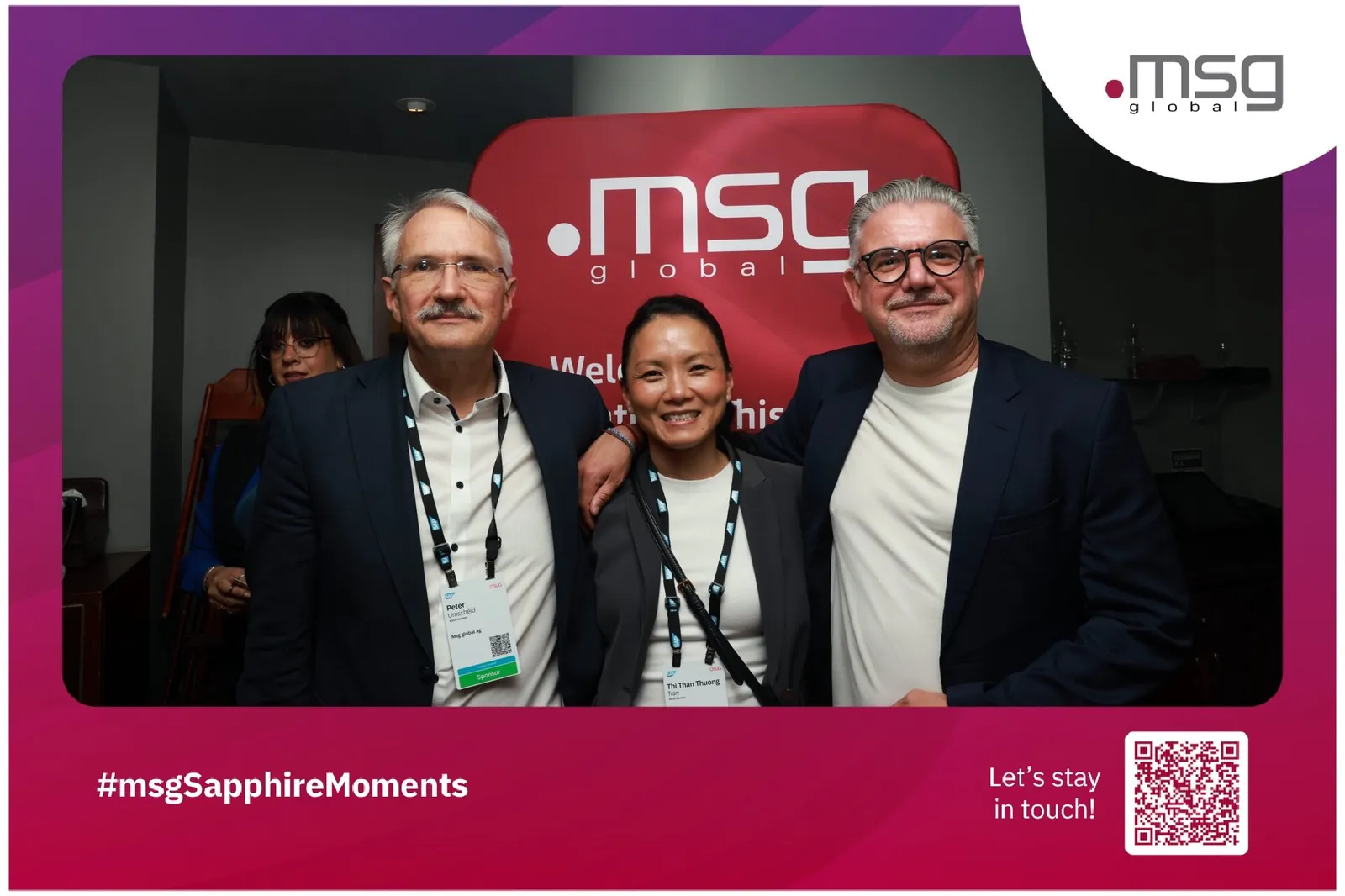 Corporate guests at a branded sponsor photo booth activation with a custom backdrop and QR code