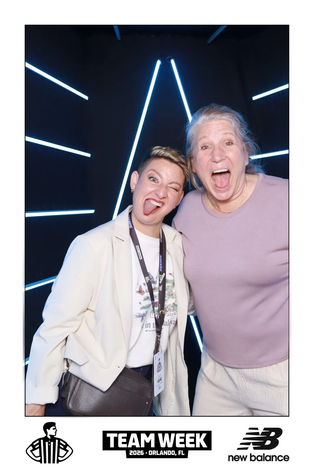 Guests at a New Balance branded photo booth activation with a custom neon backdrop