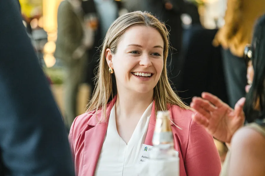 Audience photography of an attendee applauding during a corporate conference general session