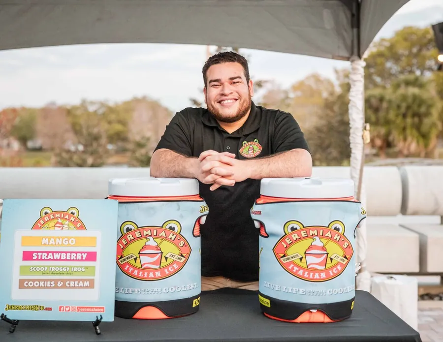 Sponsor photography of a guest presenting a branded product display at an event activation