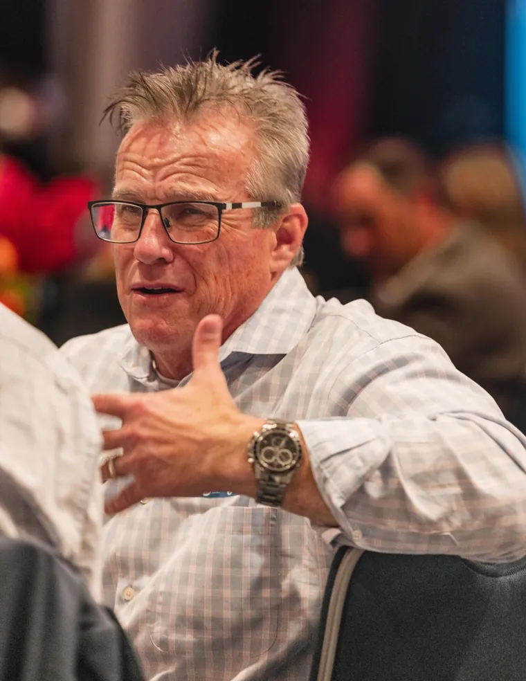 Networking photography of an attendee in conversation at a corporate reception