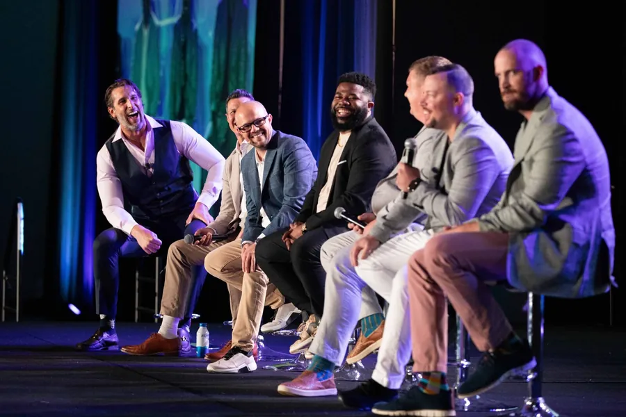 Conference panel photography of seated speakers during a corporate breakout session