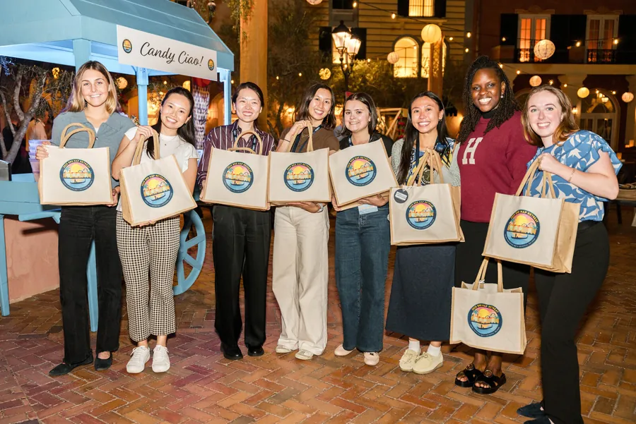 Corporate team photography of a group of attendees holding branded event swag