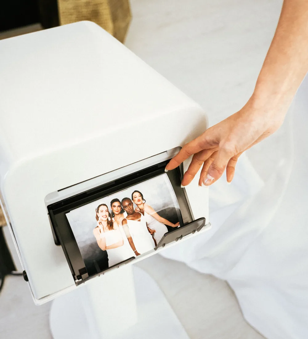 Guest taking a freshly printed Pro DSLR photo booth print from the on-site printer at an Orlando event