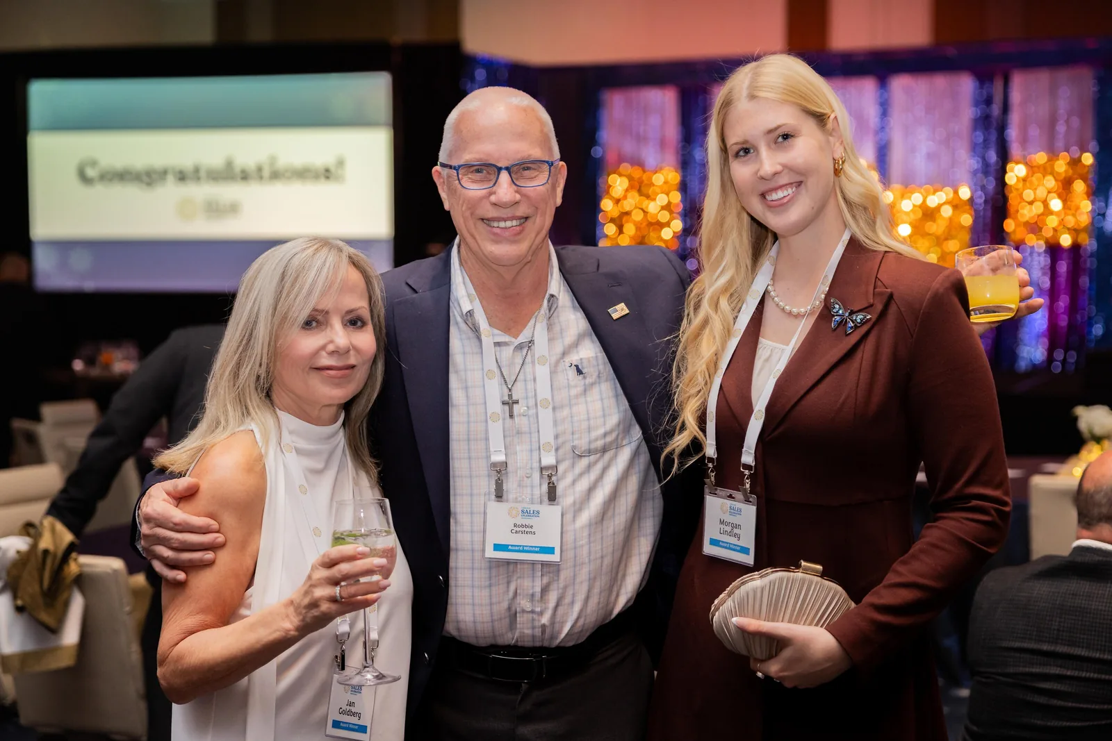 Roaming photograph of three corporate guests together at an awards reception in Orlando