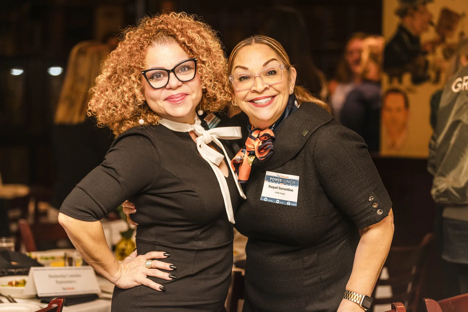 Roaming photograph of two corporate guests with name badges at a networking event in Orlando