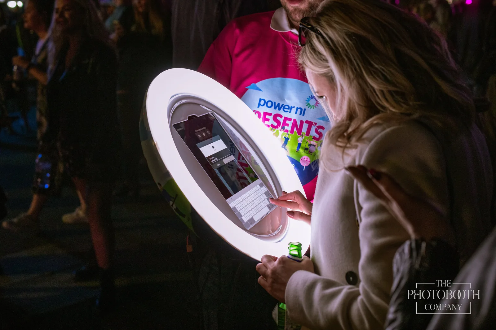 Guest instantly sharing a photo on a roaming ring-light photo booth at a branded corporate event