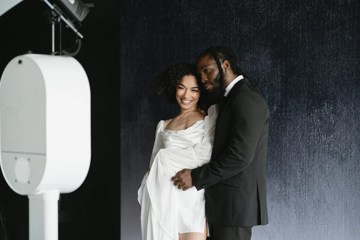 Couple posing at a luxury wedding photo booth setup at an Orlando reception