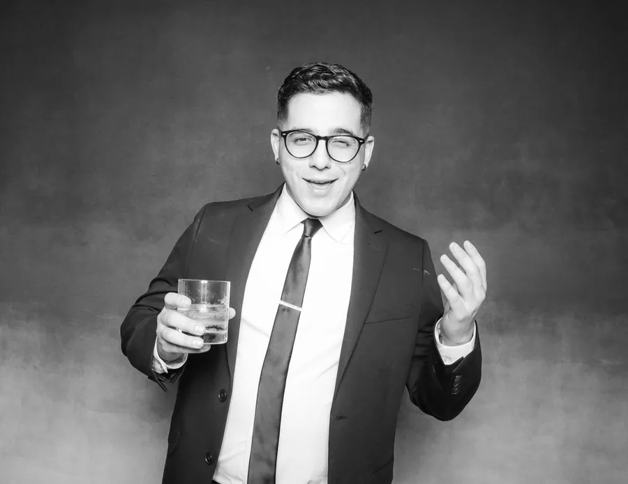 Wedding guest enjoying a black and white photo booth at an Orlando reception